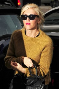 A solo Gwen Stefani sports a mustard sweater and camo trousers while out and about in London